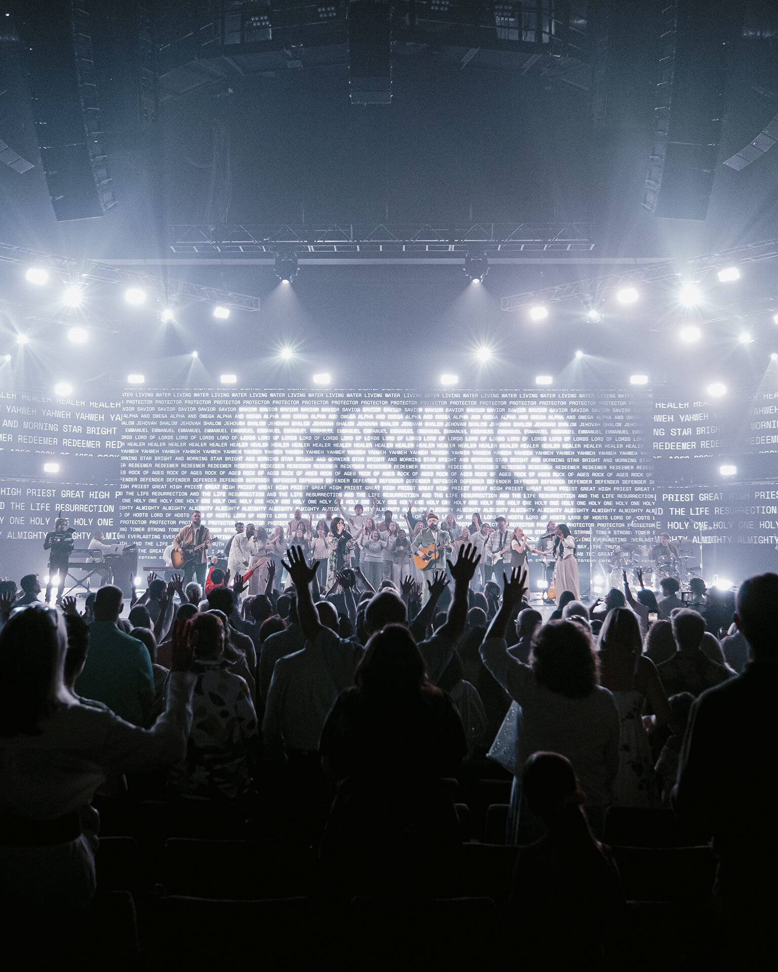 People worshipping with hands raised