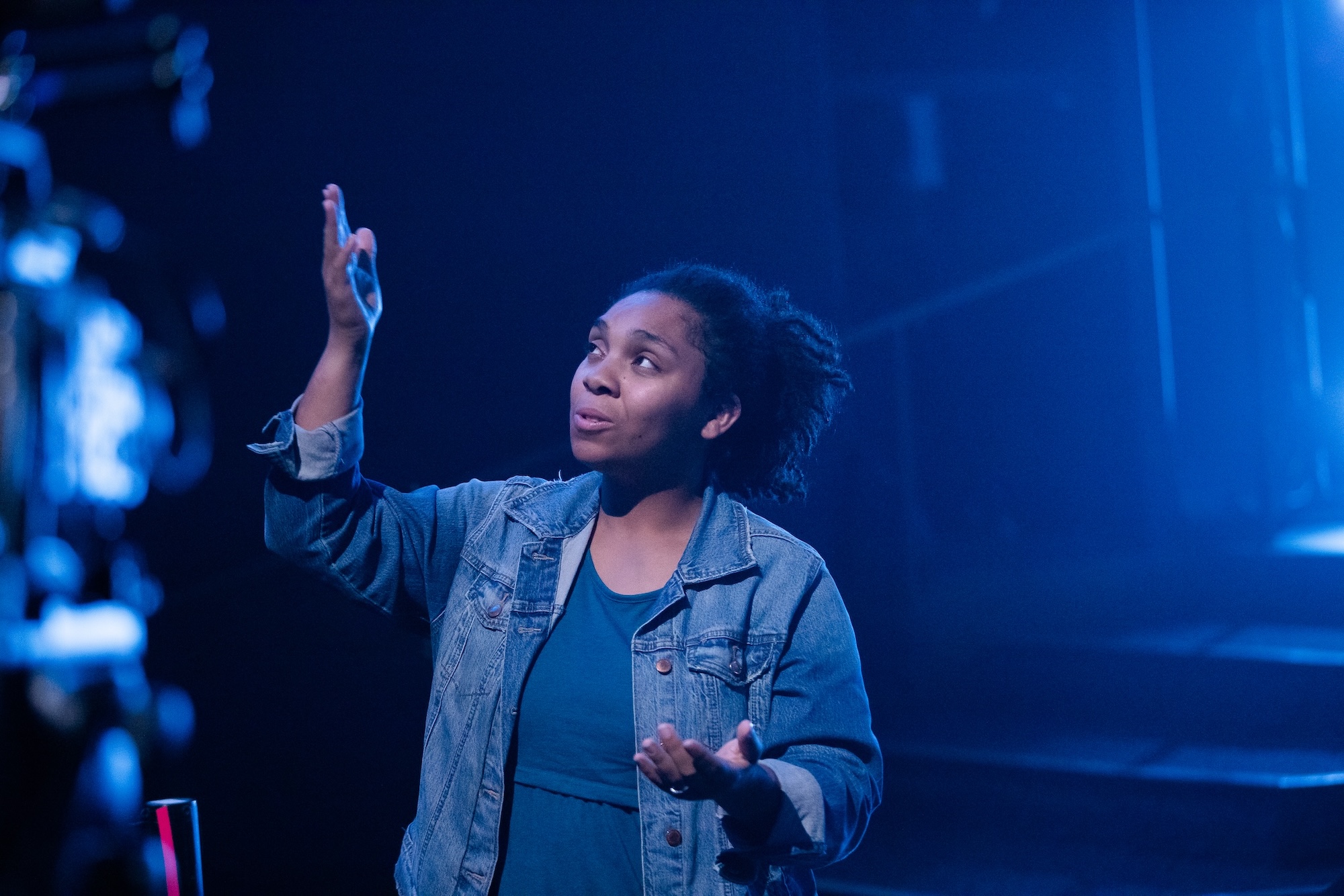 People standing around a woman in prayer