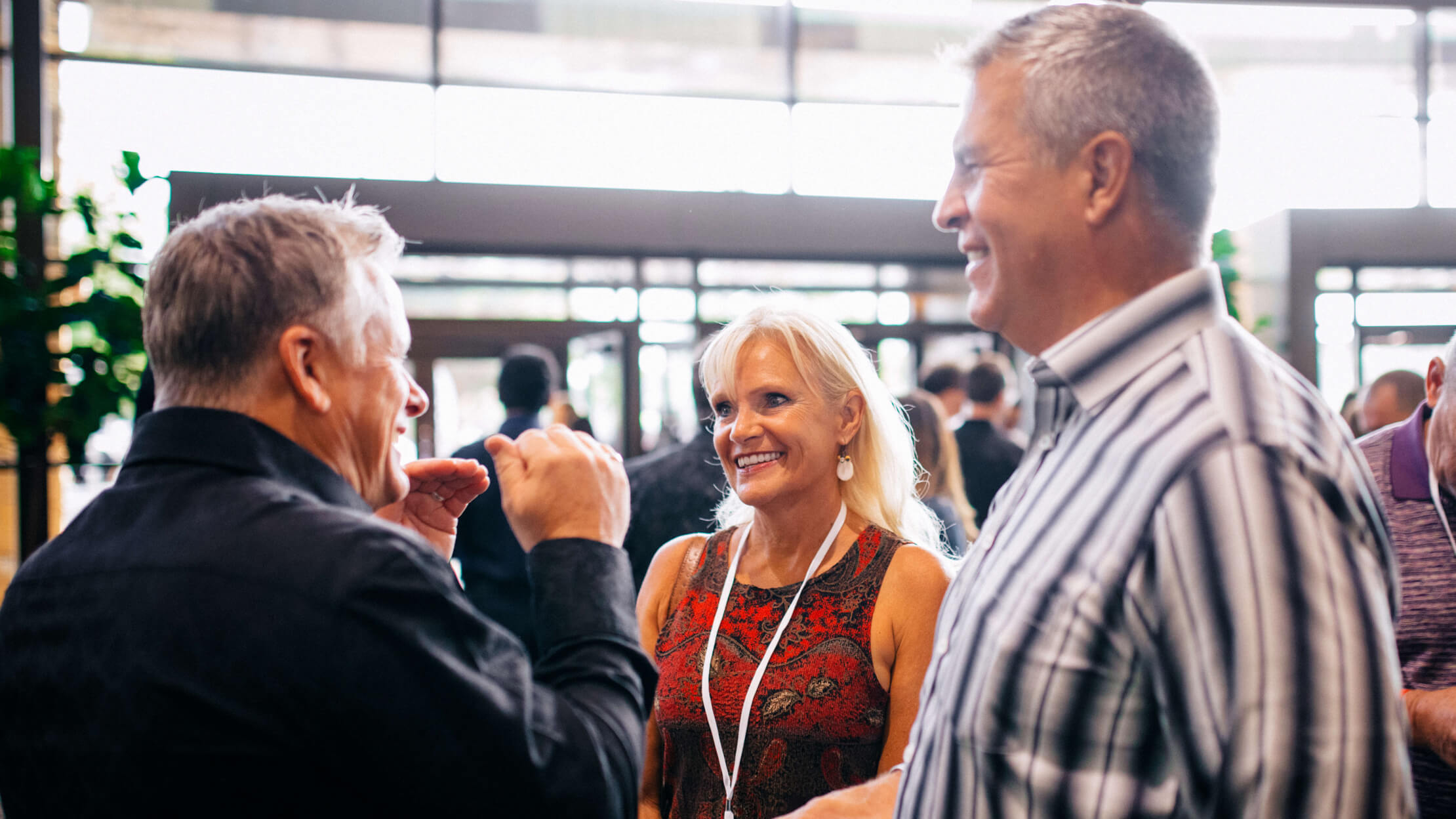 Three people talking and smiling