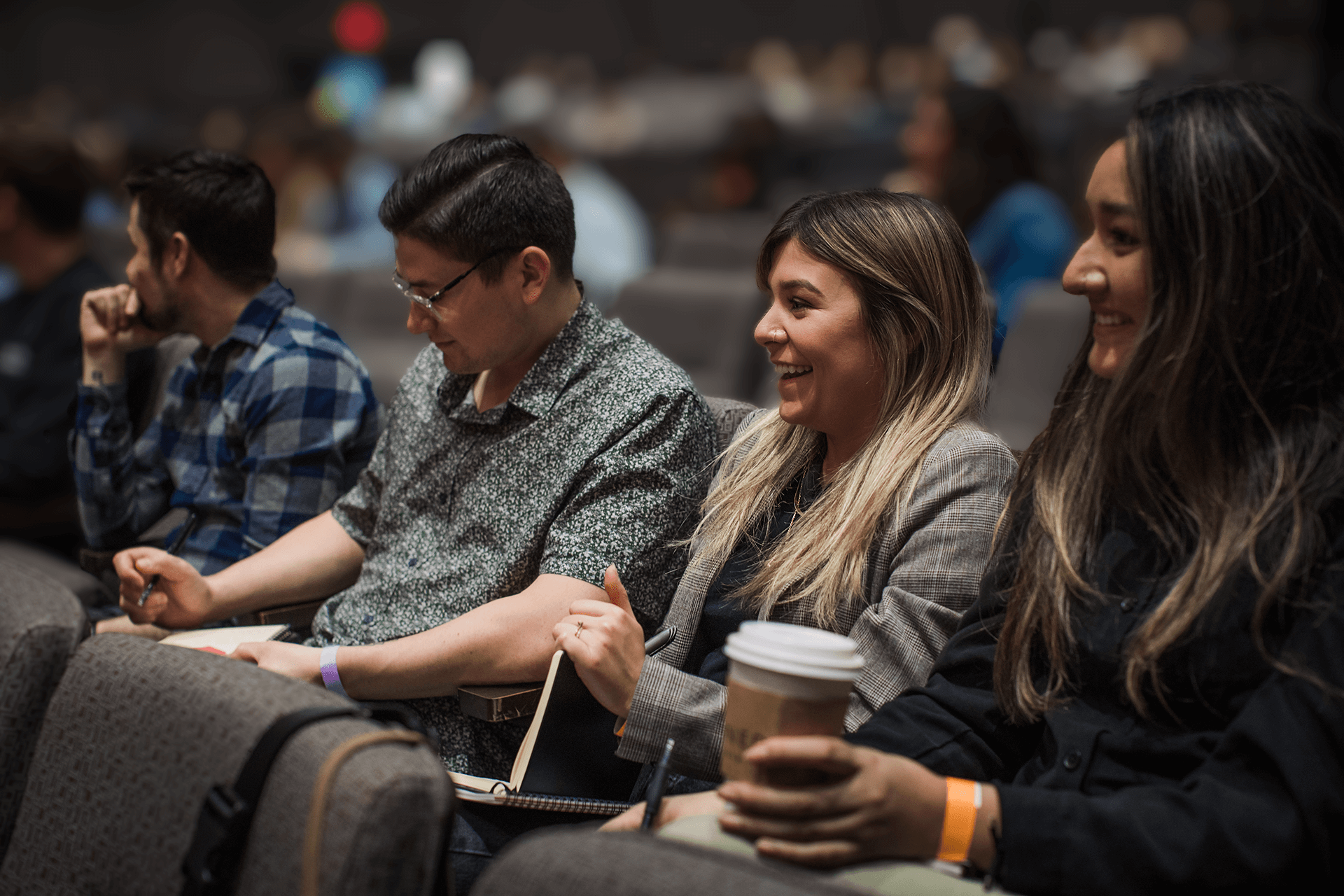 People smiling and taking notes